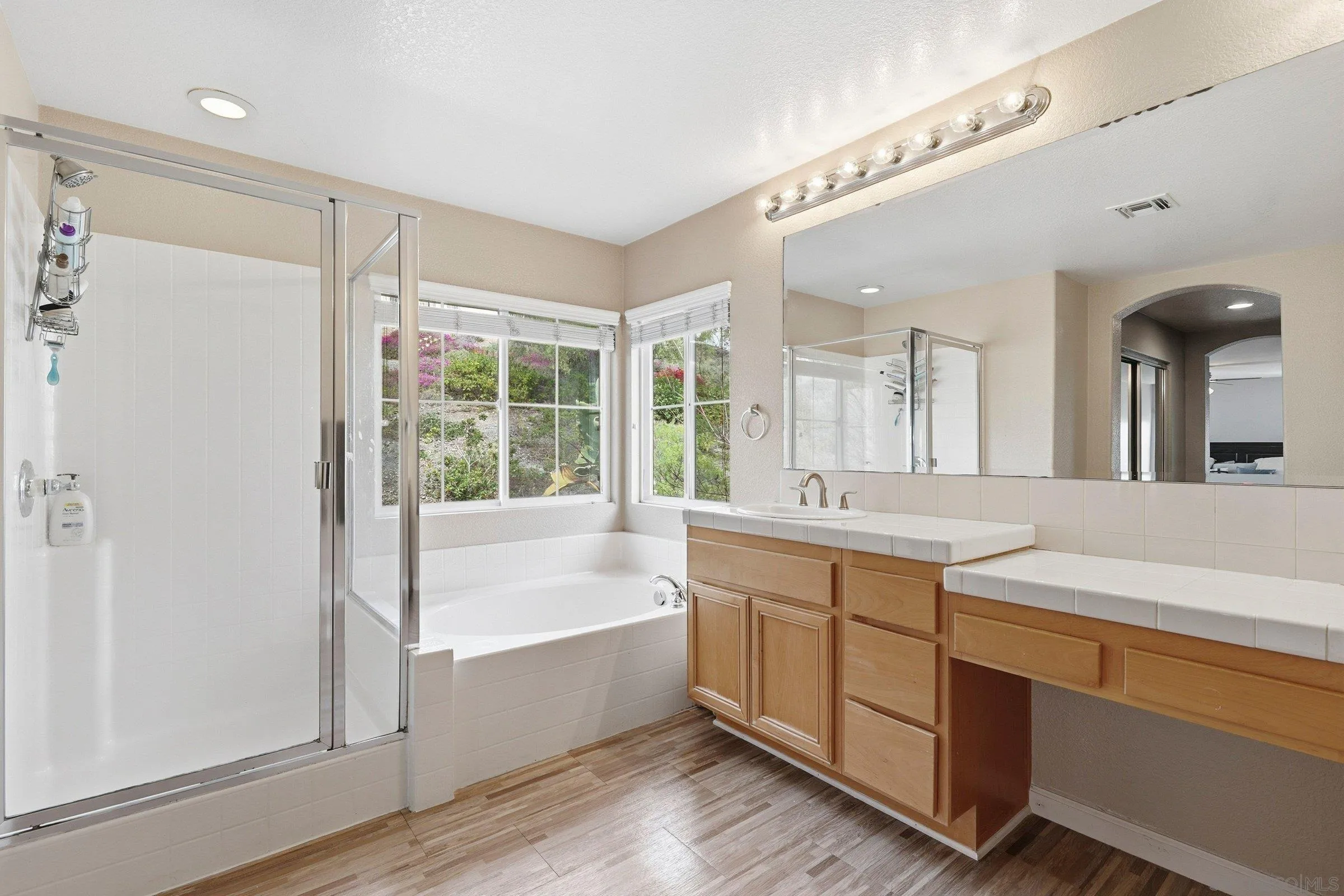 1514 West Borden Road San Marcos, CA 92069 - Photo 26 of 40 a spacious bathroom with a tub sink and mirror