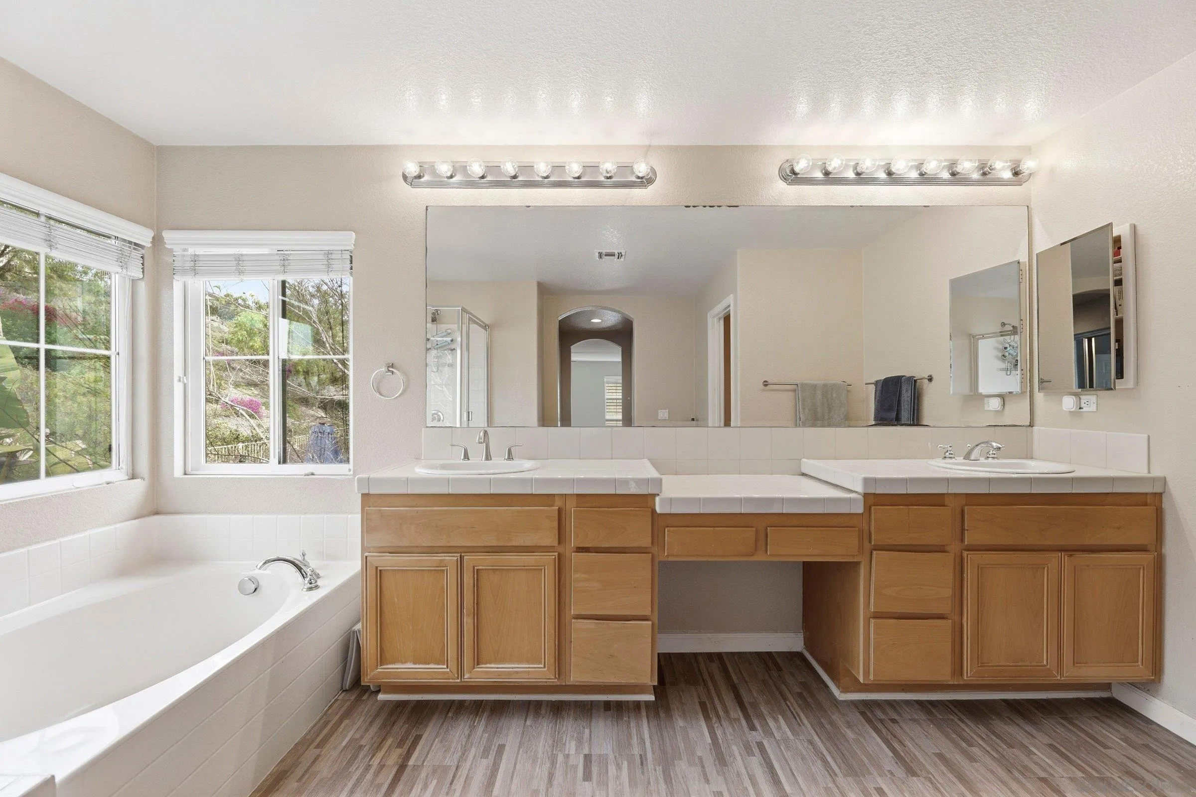 1514 West Borden Road San Marcos, CA 92069 - Photo 27 of 40 a spacious bathroom with a tub double sink and mirror