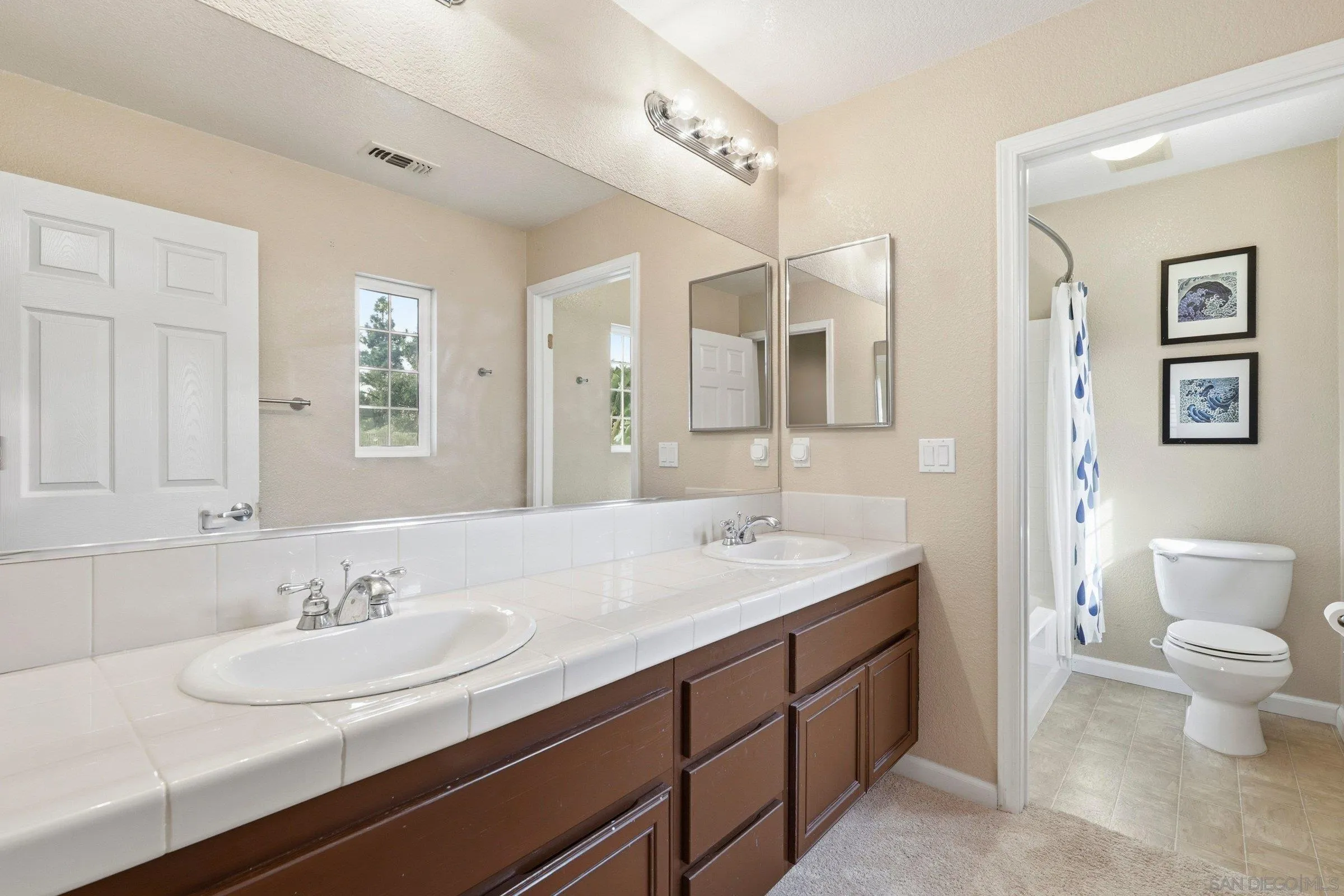 1514 West Borden Road San Marcos, CA 92069 - Photo 29 of 40 a bathroom with a sink double vanity and a toilet