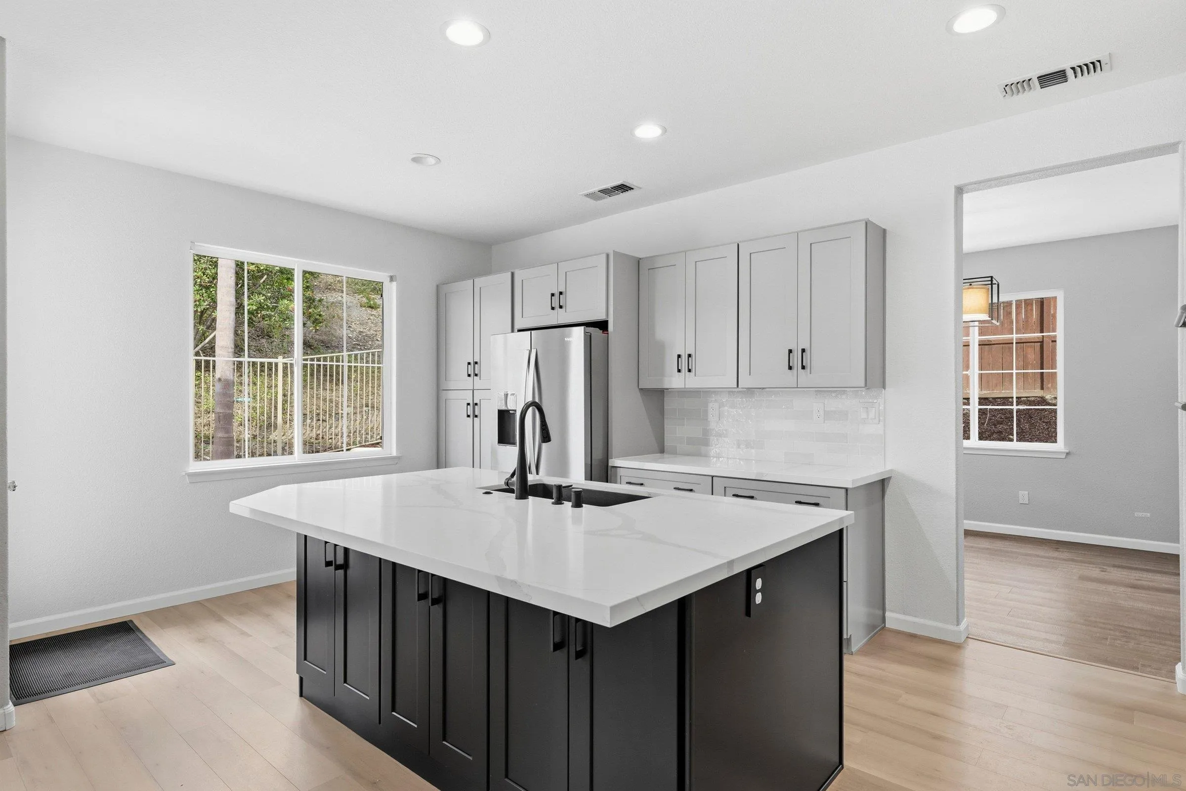 1514 West Borden Road San Marcos, CA 92069 - Photo 8 of 40 a kitchen with a sink a stove a center island and a window