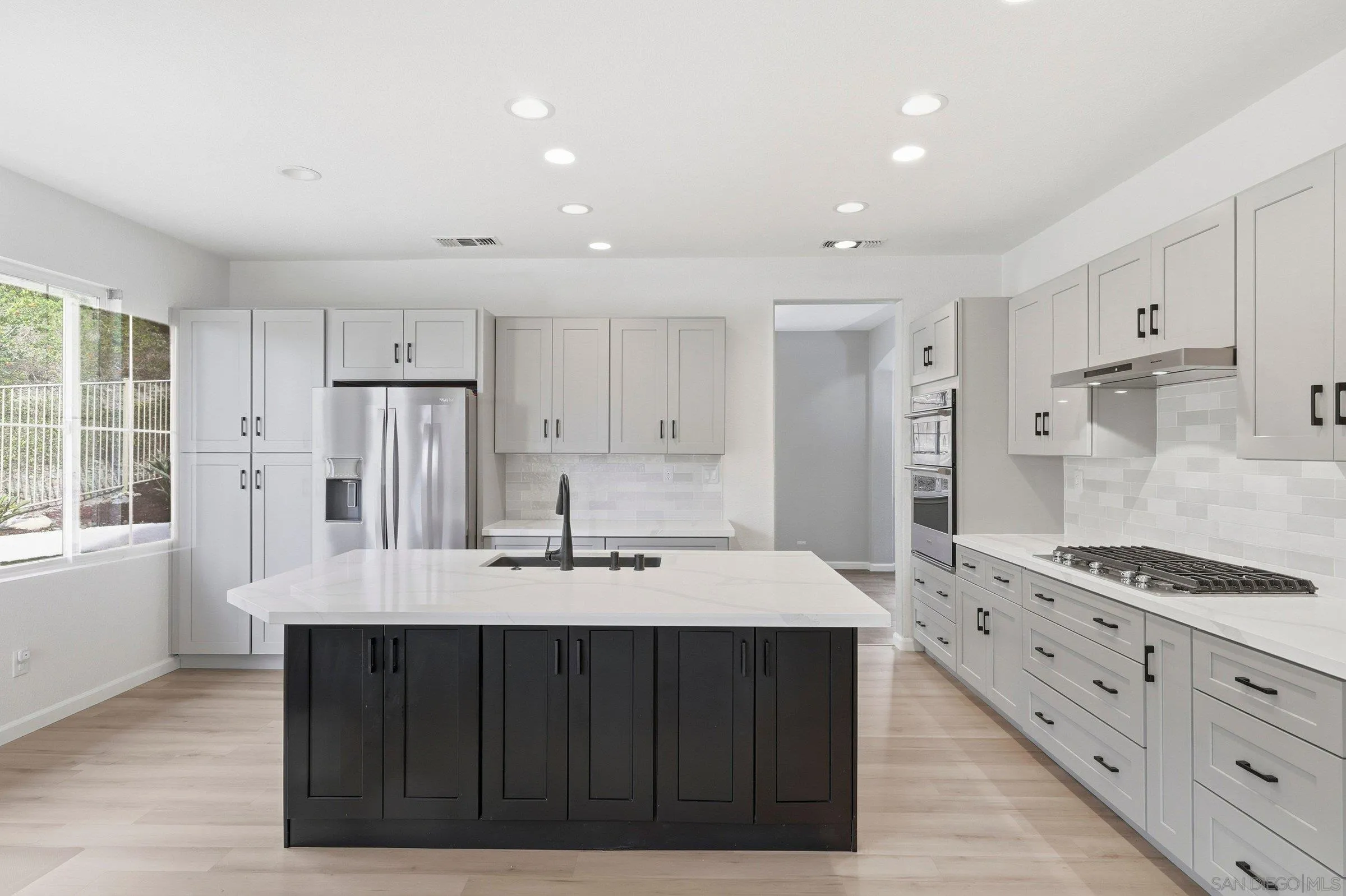1514 West Borden Road San Marcos, CA 92069 - Photo 9 of 40 a kitchen with stainless steel appliances kitchen island granite countertop a refrigerator and a stove top oven