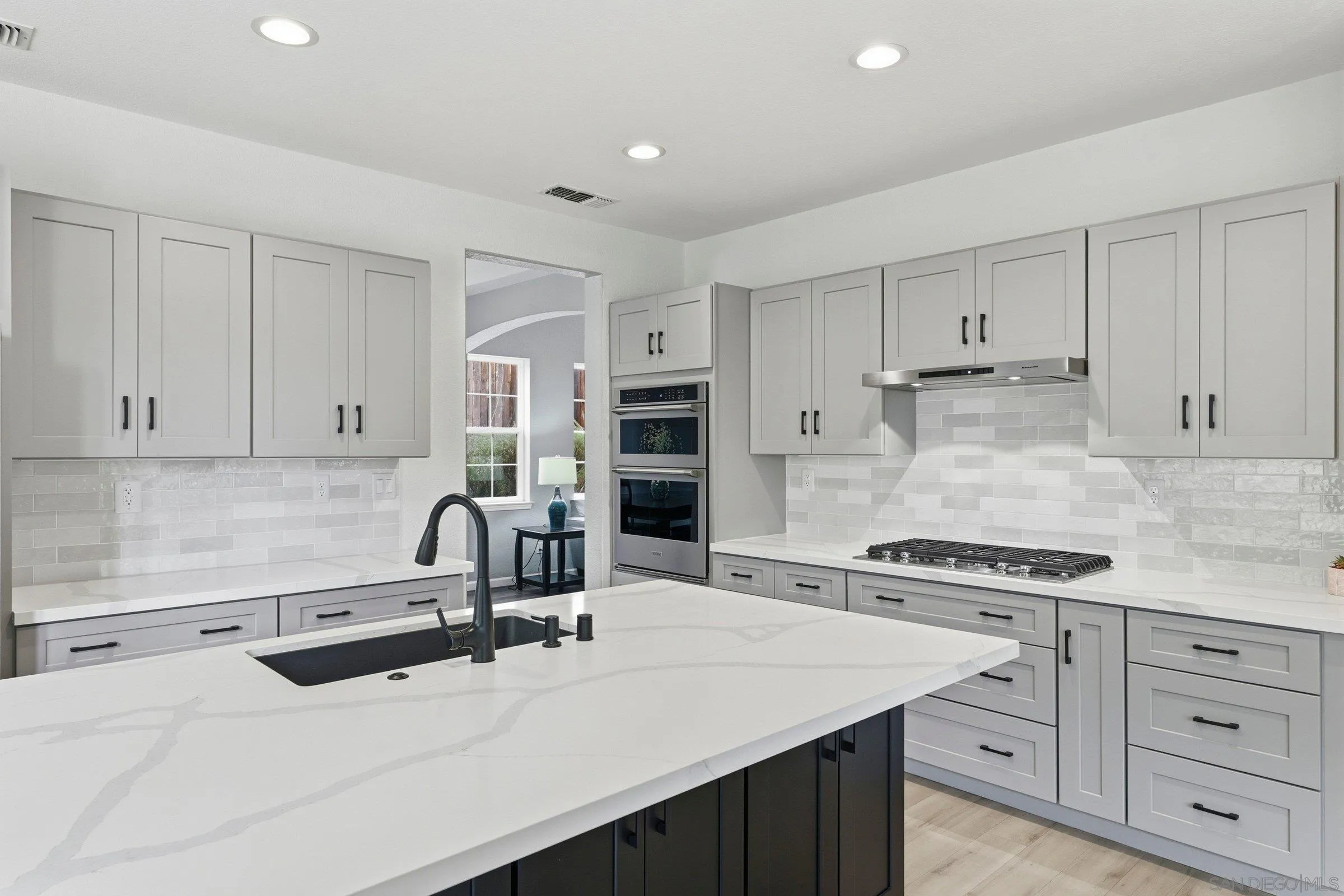 1514 West Borden Road San Marcos, CA 92069 - Photo 10 of 40 a kitchen with a sink stove and cabinets