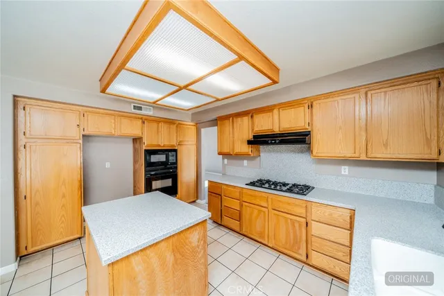 a large kitchen with stainless steel appliances granite countertop a sink and a stove next to a window