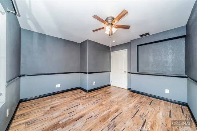 a bedroom with two beds and a window