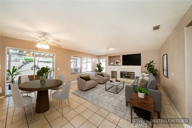 a view of an empty room with window and chandelier fan