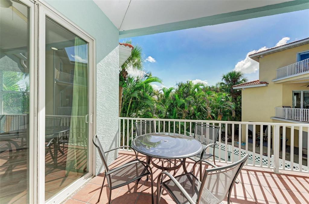 201 57th Street Holmes Beach, FL 34217 - Photo 12 of 48 a view of a chair and table in the balcony