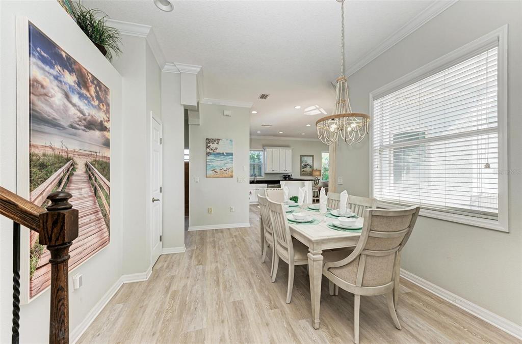 201 57th Street Holmes Beach, FL 34217 - Photo 14 of 48 a view of a dining room with furniture window and wooden floor