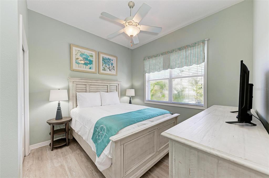 201 57th Street Holmes Beach, FL 34217 - Photo 15 of 48 a bedroom with a bed and a flat screen tv
