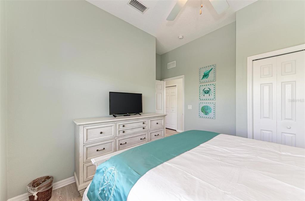 201 57th Street Holmes Beach, FL 34217 - Photo 16 of 48 a bedroom with a bed and a flat screen tv