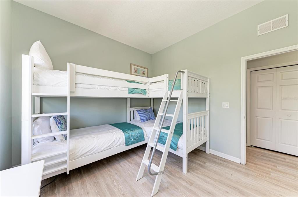 201 57th Street Holmes Beach, FL 34217 - Photo 19 of 48 a bedroom with a bed and a chair