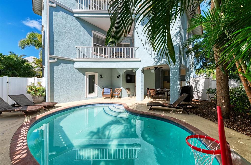 201 57th Street Holmes Beach, FL 34217 - Photo 2 of 48 a view of a house with backyard swimming pool and sitting area