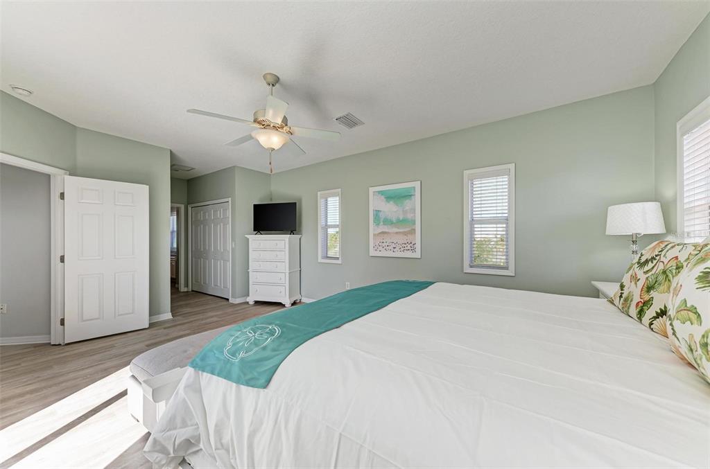 201 57th Street Holmes Beach, FL 34217 - Photo 23 of 48 a bedroom with a large bed and a window