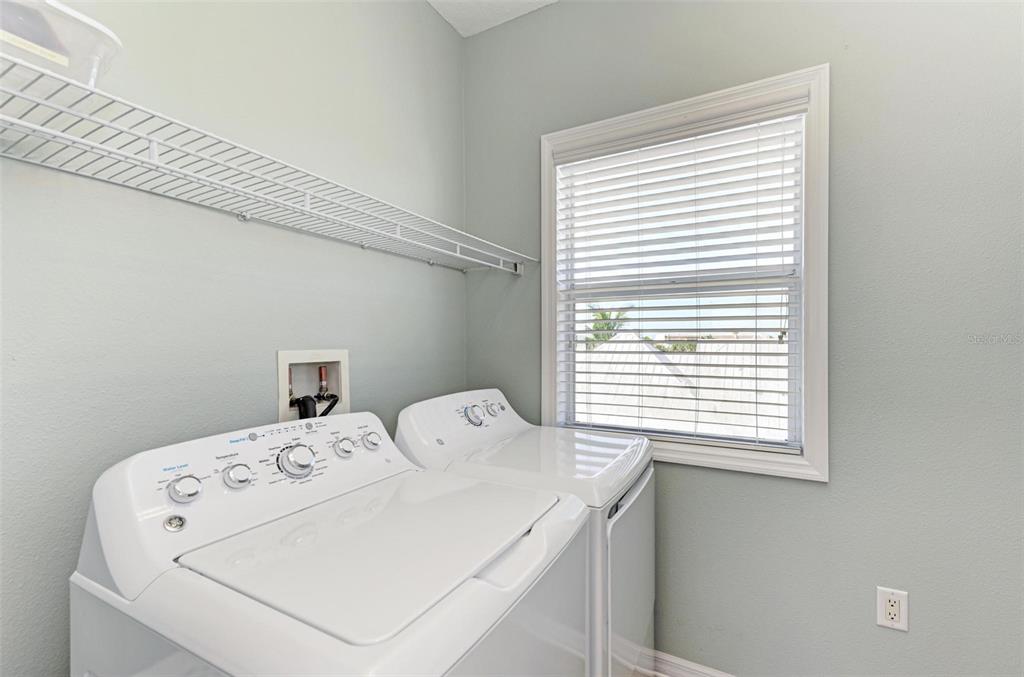 201 57th Street Holmes Beach, FL 34217 - Photo 30 of 48 a utility room with a window dryer and washer