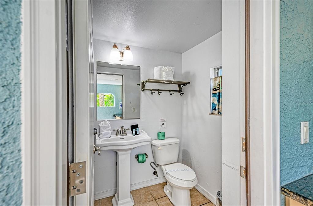 201 57th Street Holmes Beach, FL 34217 - Photo 34 of 48 a bathroom with a sink toilet and shower