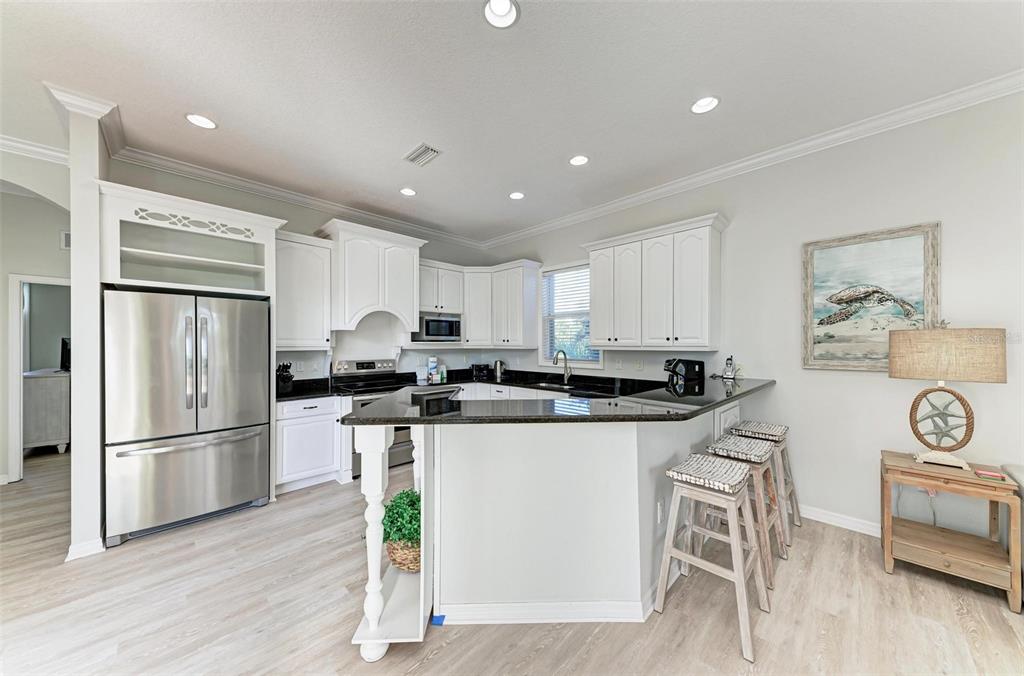 201 57th Street Holmes Beach, FL 34217 - Photo 6 of 48 a kitchen with stainless steel appliances a refrigerator a stove a sink and a refrigerator
