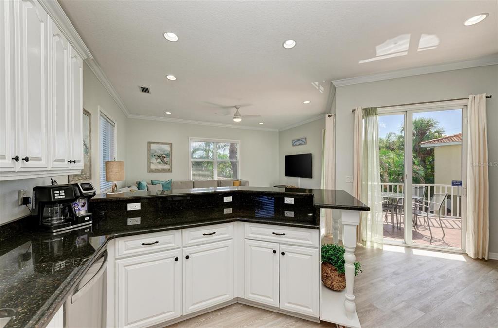 201 57th Street Holmes Beach, FL 34217 - Photo 8 of 48 a kitchen with granite countertop a stove a sink and a granite counter tops