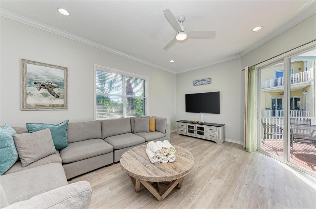 201 57th Street Holmes Beach, FL 34217 - Photo 10 of 48 a living room with furniture and a flat screen tv
