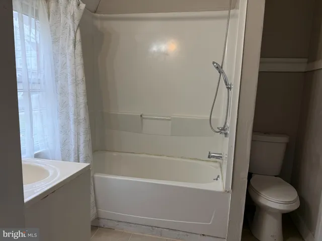 a bathroom with a bathtub and a toilet