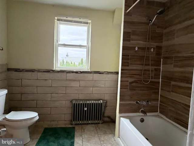 a bathroom with a toilet and shower