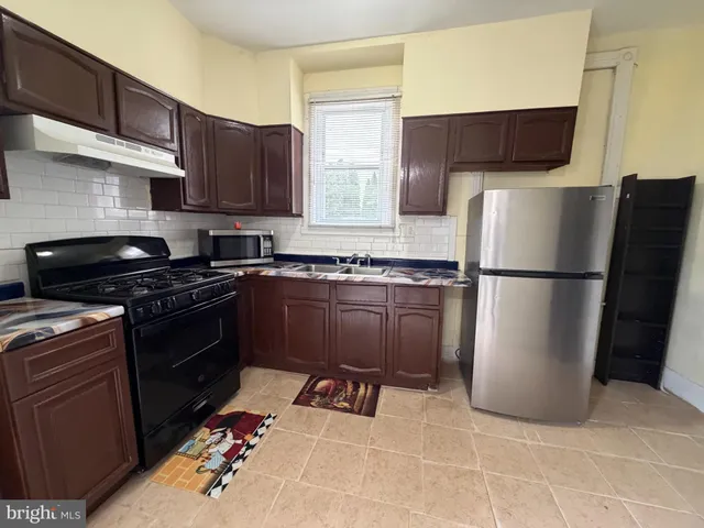 a kitchen with a refrigerator and a sink