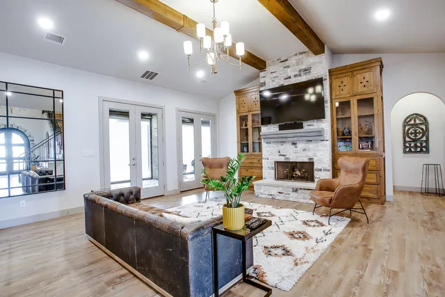 a living room with fireplace furniture and a flat screen tv