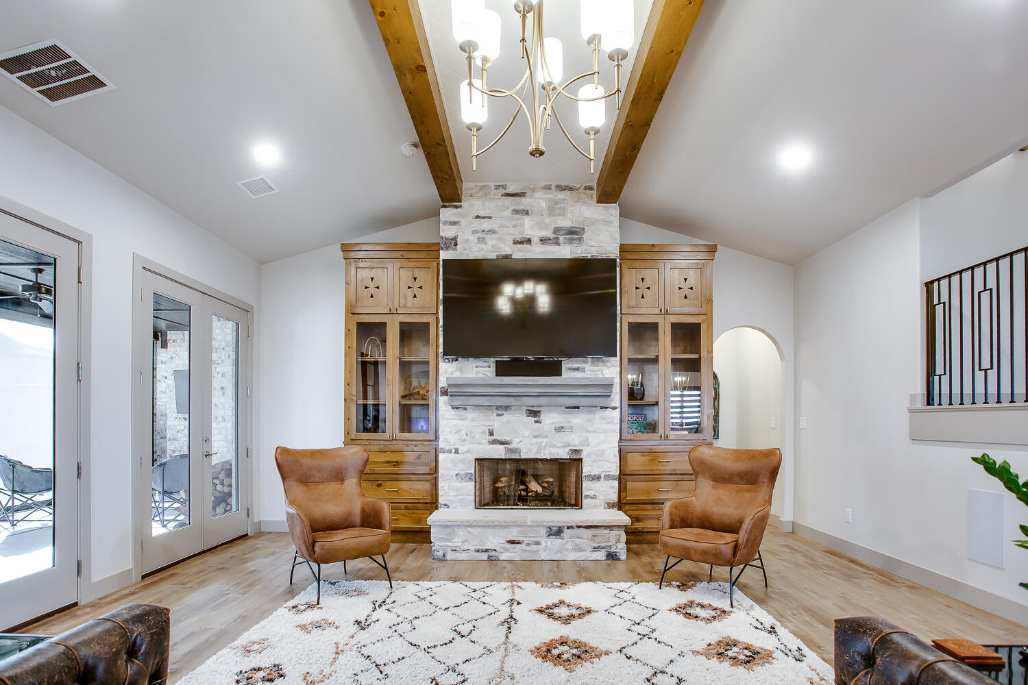 7601 53rd Street Lubbock, TX 79407 - Photo 14 of 33 a living room with furniture a flat screen tv and a fireplace