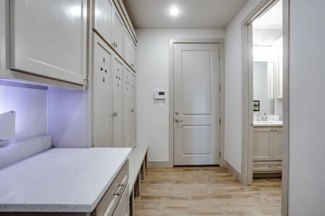 a view of a hallway with wooden floor