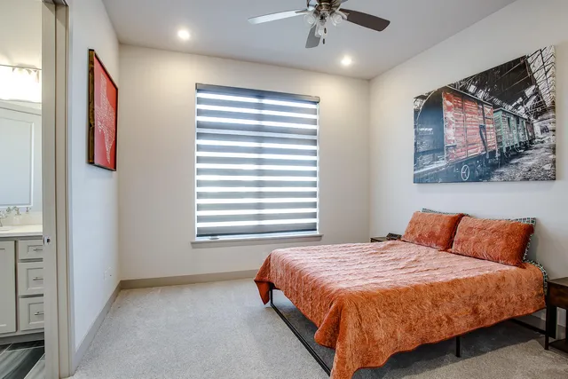 a bedroom with a bed and ceiling fan
