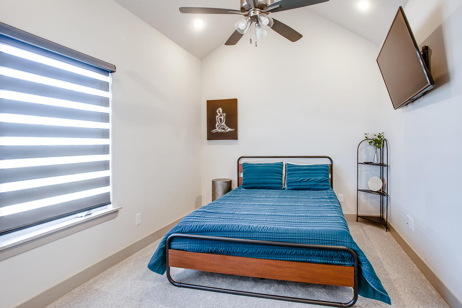 7601 53rd Street Lubbock, TX 79407 - Photo 26 of 33 a bedroom with a bed and a flat screen tv