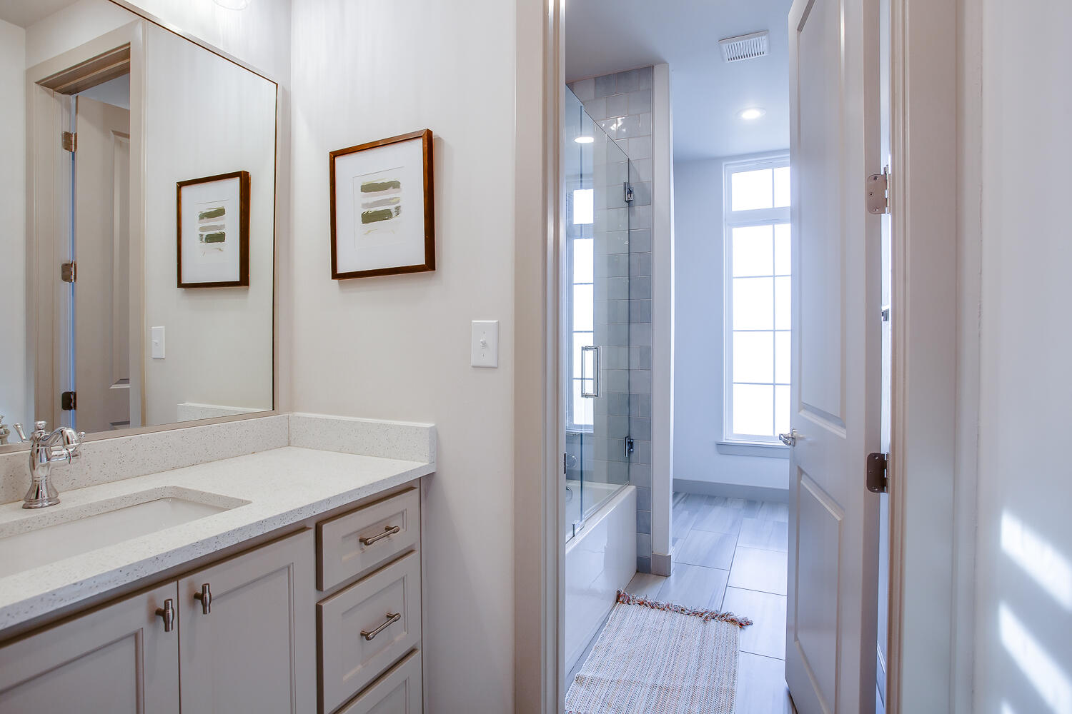 7601 53rd Street Lubbock, TX 79407 - Photo 29 of 33 a en suite bathroom with a sink mirror and a shower