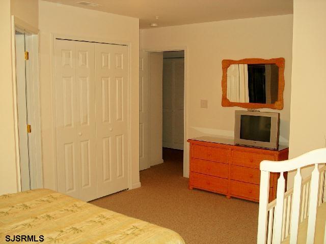 107 East Taylor Avenue, Unit C Wildwood, NJ 08260 - Photo 5 of 5 a bedroom with a bed and cabinets