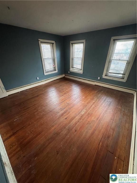 4856 Huckleberry Road Orefield, PA 18069 - Photo 19 of 23 an empty room with wooden floor and windows