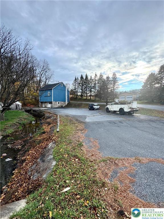 4856 Huckleberry Road Orefield, PA 18069 - Photo 3 of 23 a view of a dirt road and trees