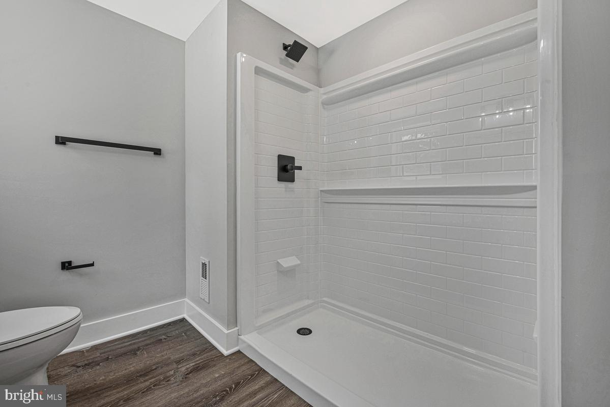 2105 Queens Chapel Road Mount Rainier, MD 20712 - Photo 26 of 33 a bathroom with a granite countertop toilet a sink and shower