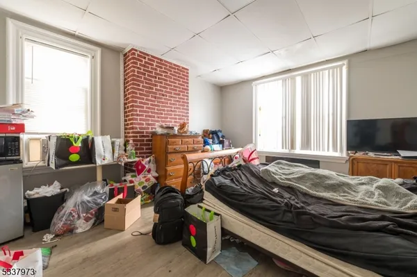 a bedroom with a bed and a desk in it