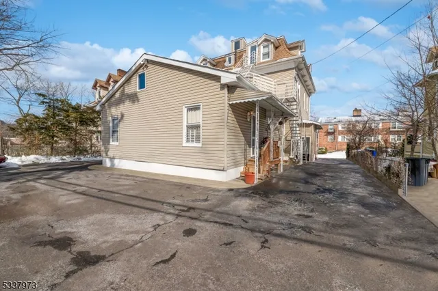 an aerial view of a house with a yard and large tree