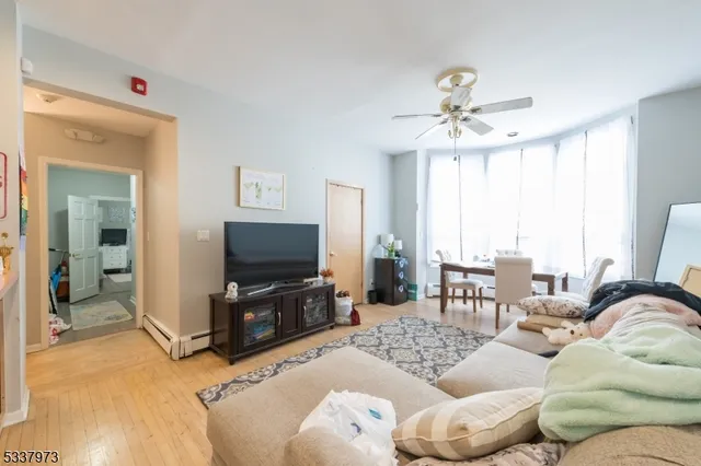 a bedroom with a bed and a flat tv screen on the dresser