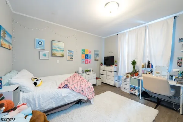 a bedroom with a bed and flat screen tv