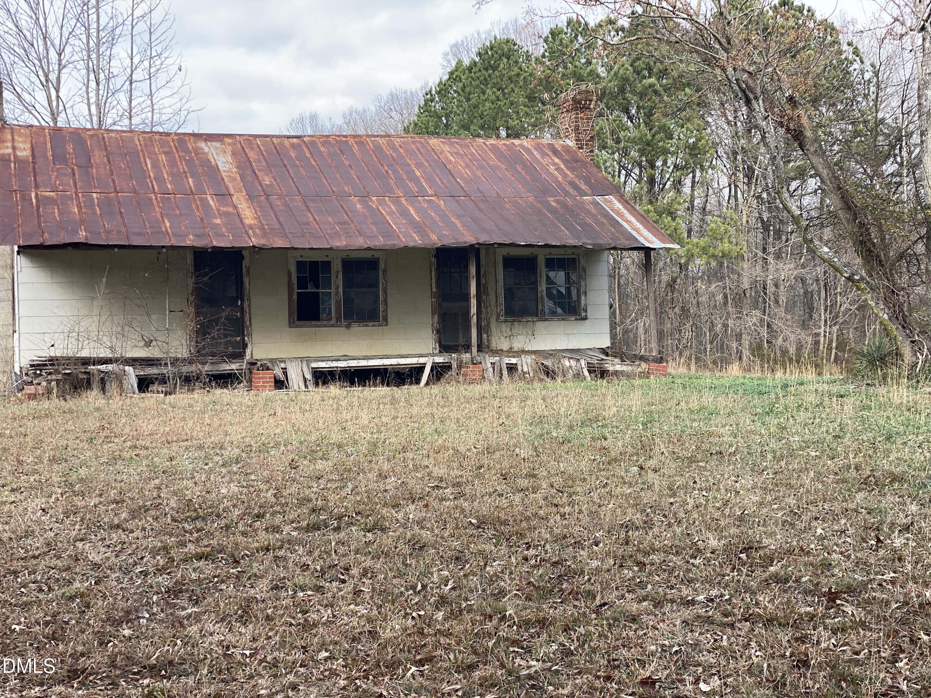 7157 Joe Branson Road Bennett, NC 27208 - Photo 23 of 25 a front view of house with yard and trees in the background