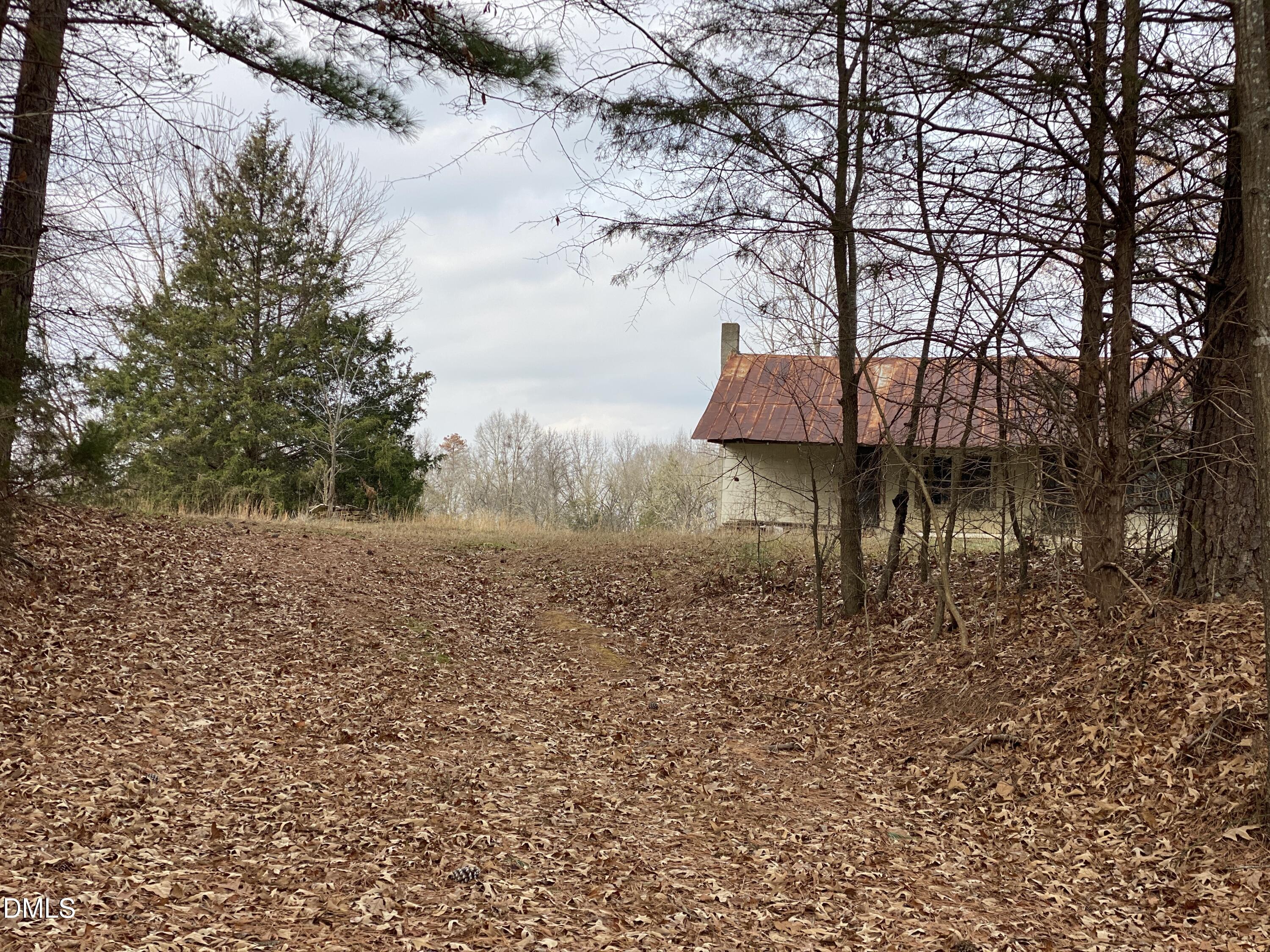 7157 Joe Branson Road Bennett, NC 27208 - Photo 24 of 25 a backyard of a house with table and chairs
