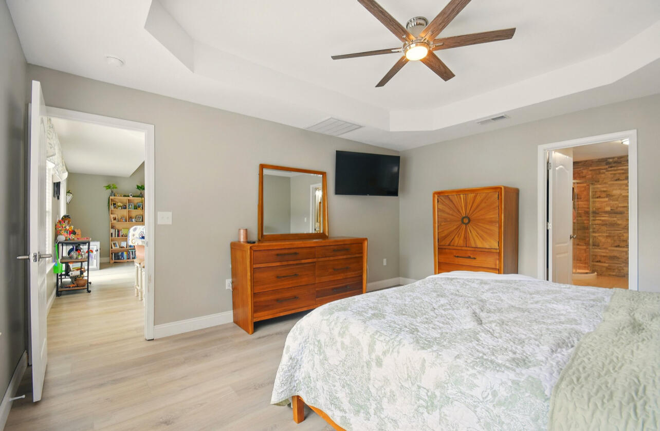6474 Moonlight Lane Crestview, FL 32539 - Photo 12 of 39 a bedroom with a bed and wooden floor