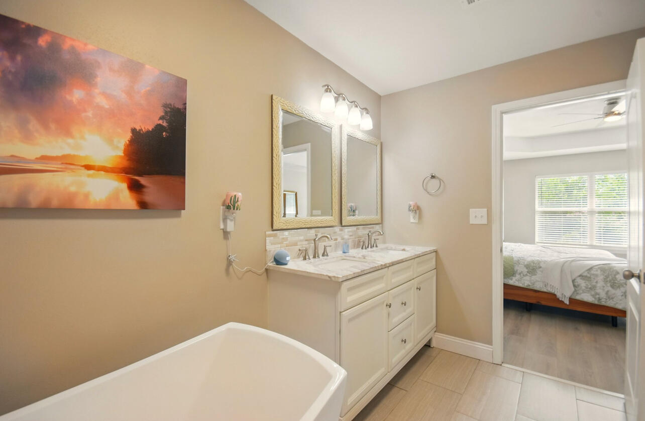 6474 Moonlight Lane Crestview, FL 32539 - Photo 14 of 39 a en suite bathroom with a double vanity sink and a mirror
