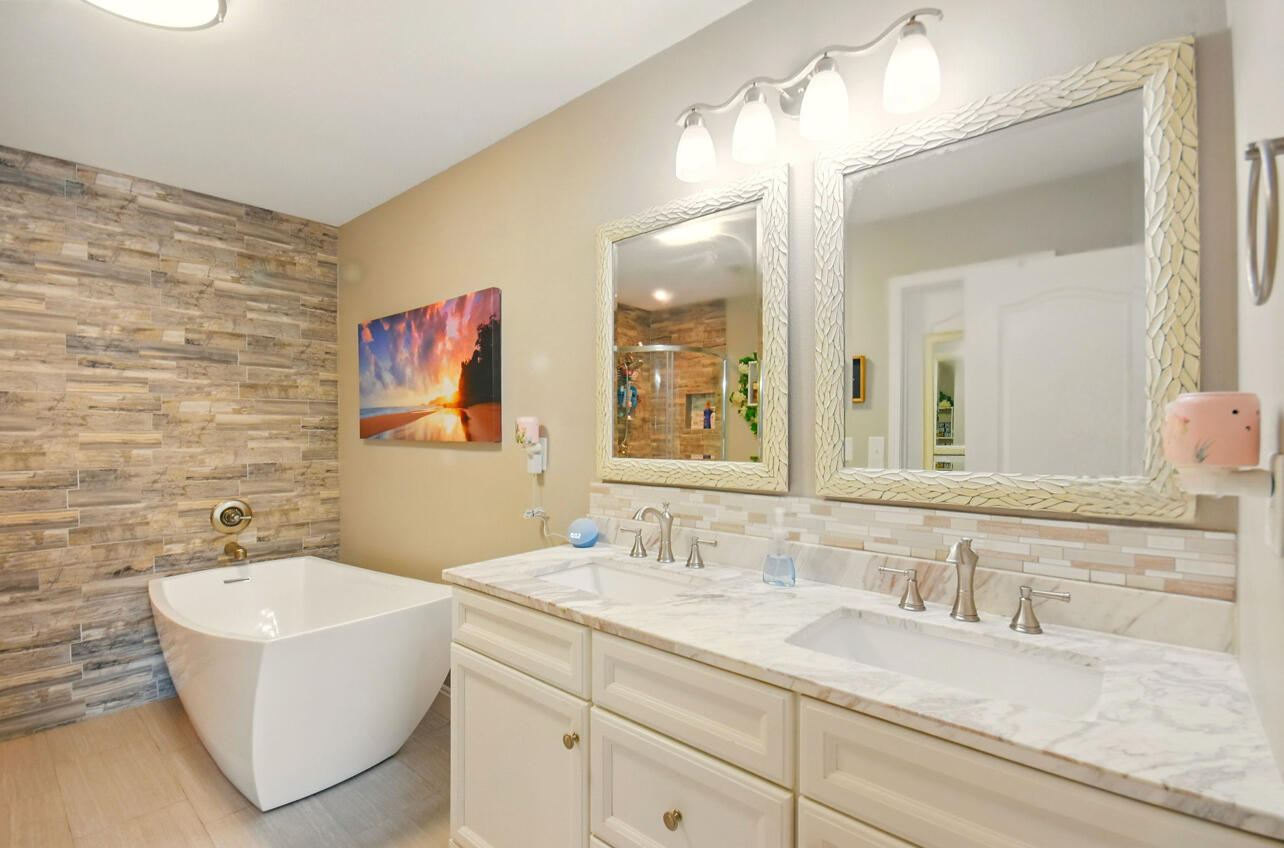 6474 Moonlight Lane Crestview, FL 32539 - Photo 15 of 39 a bathroom with a granite countertop sink a mirror and a bathtub