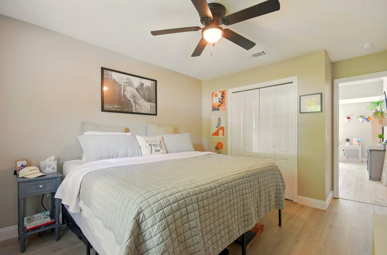 6474 Moonlight Lane Crestview, FL 32539 - Photo 17 of 39 a bedroom with a bed and a chandelier