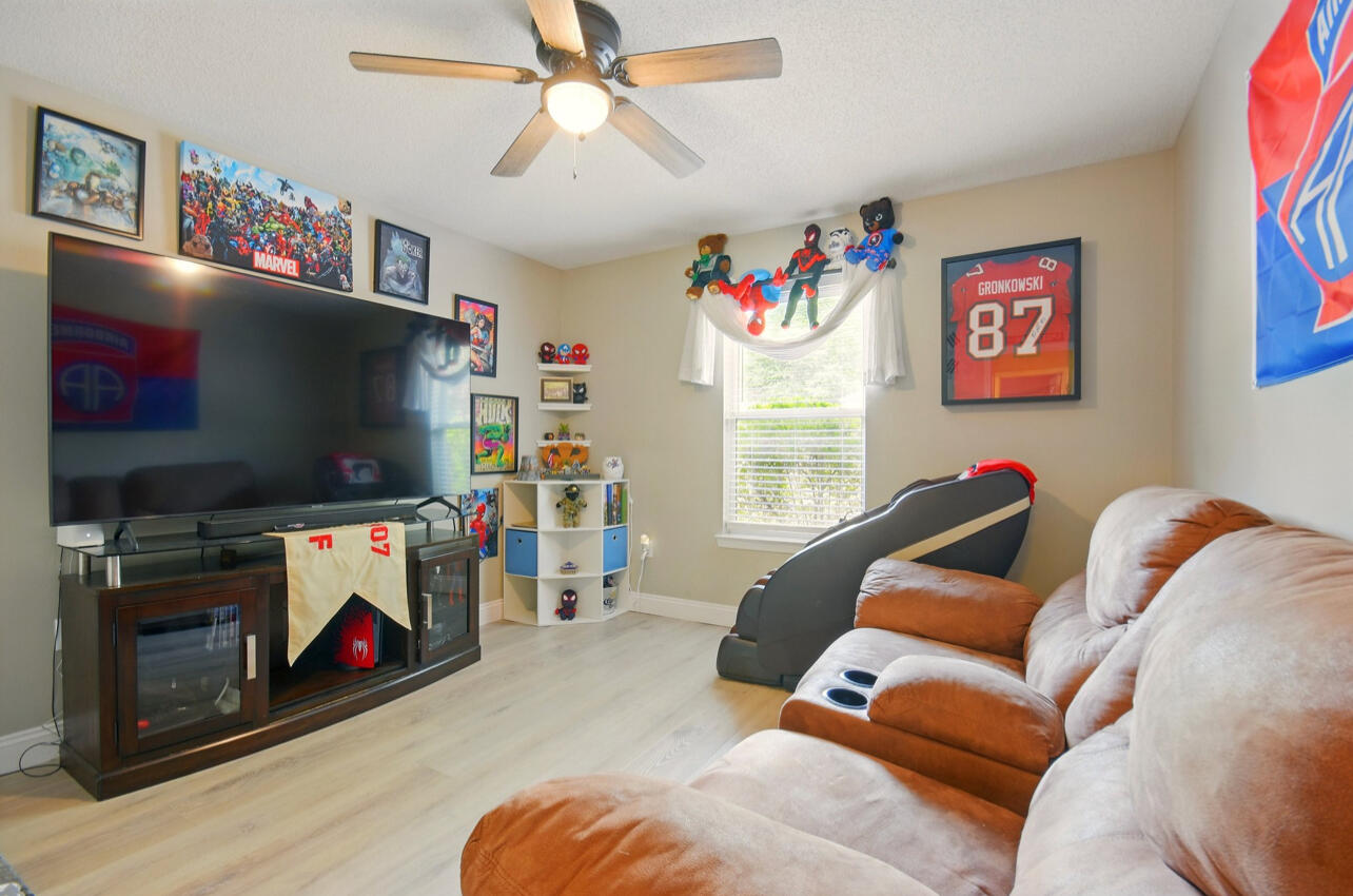 6474 Moonlight Lane Crestview, FL 32539 - Photo 19 of 39 a living room with furniture and a flat screen tv