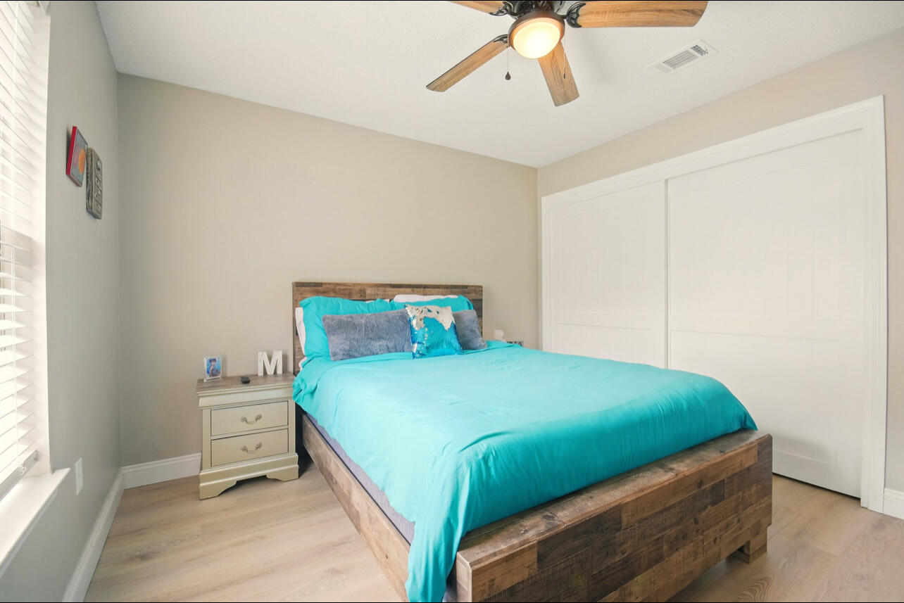6474 Moonlight Lane Crestview, FL 32539 - Photo 23 of 39 a bedroom with a bed a window and closet