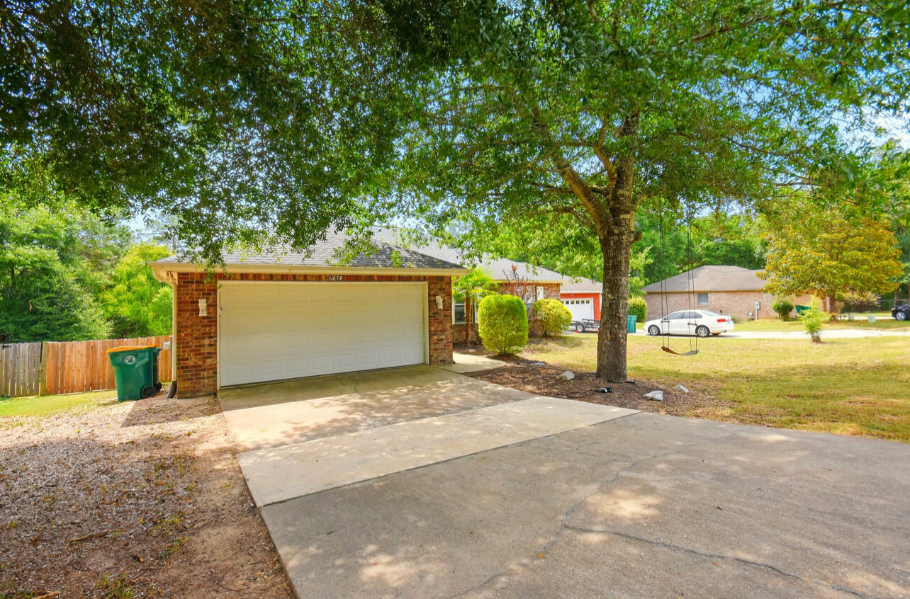 6474 Moonlight Lane Crestview, FL 32539 - Photo 3 of 39 a view of a yard with a tree