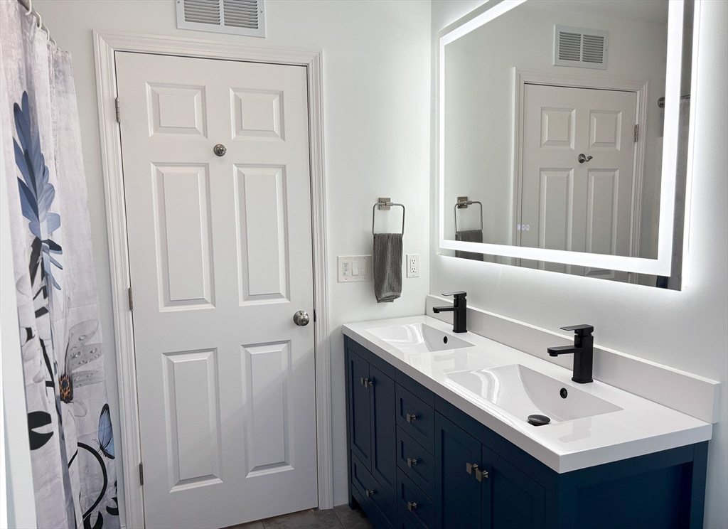 14 Cavite Street Devens, MA 01434 - Photo 25 of 40 a bathroom with double vanity sink and a mirror