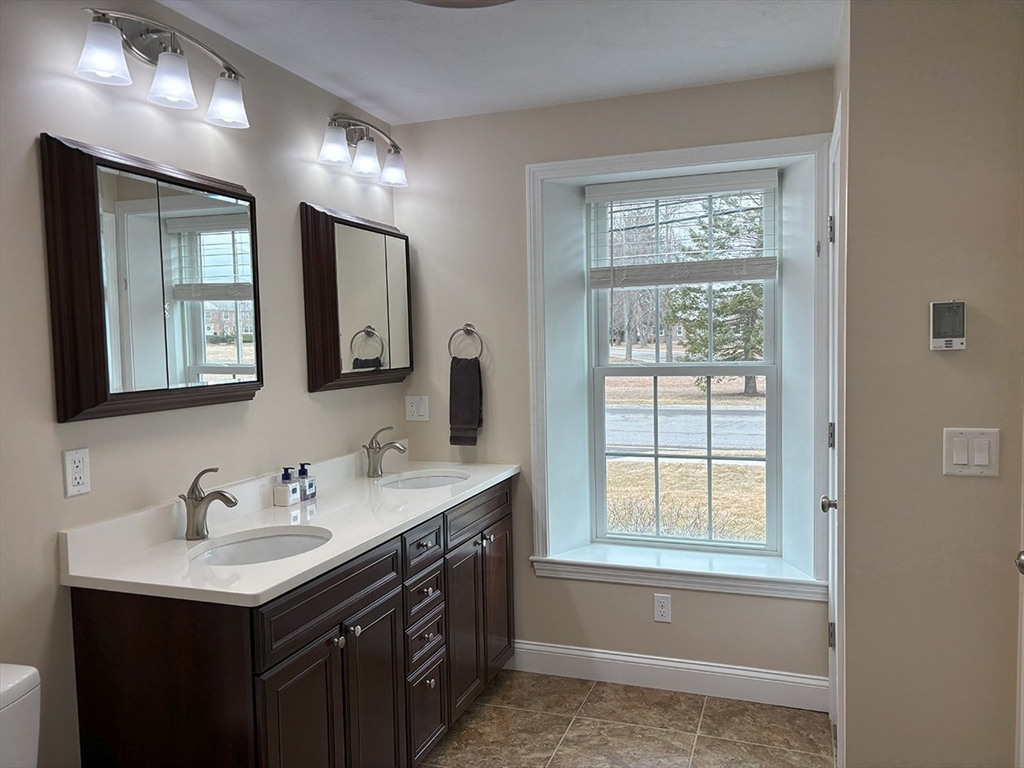 14 Cavite Street Devens, MA 01434 - Photo 26 of 40 a bathroom with a sink vanity and a mirror