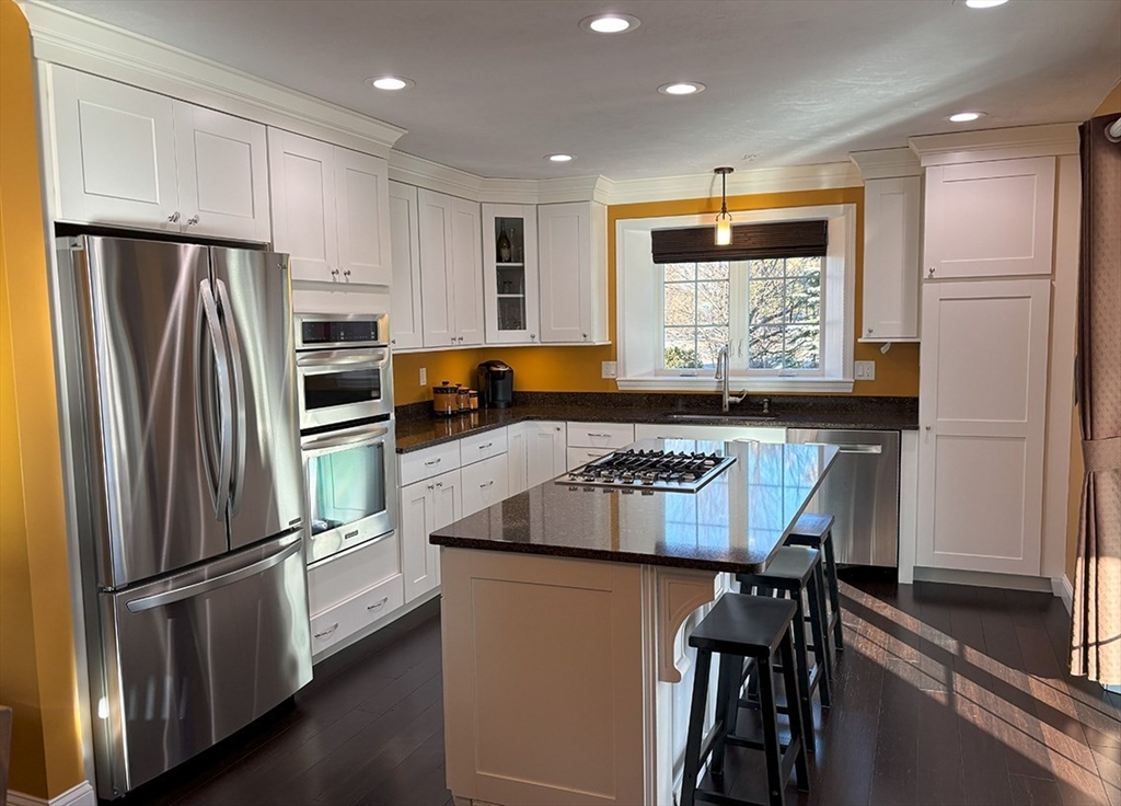 14 Cavite Street Devens, MA 01434 - Photo 9 of 40 a kitchen with stainless steel appliances granite countertop a refrigerator and a stove top oven